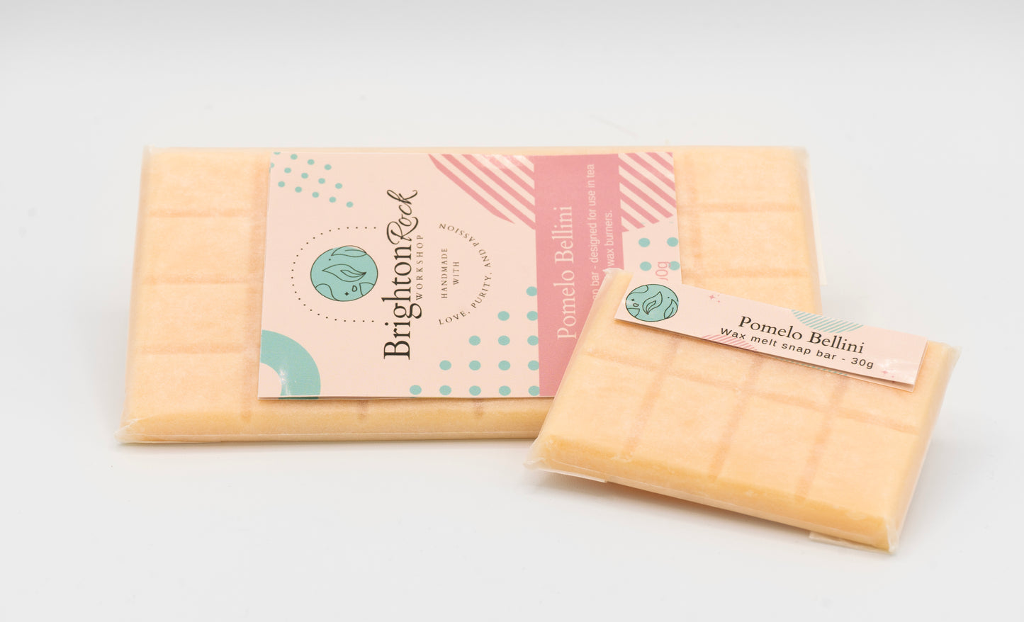Pomelo bellini pink champagne scented 30g or 90g strongly scented wax melt snap bars. Eco friendly waxed paper packaging. Brighton Rock Workshop wax melts made in Spain and the United Kingdom, available in two sizes. Suitable for tea light or electric burners