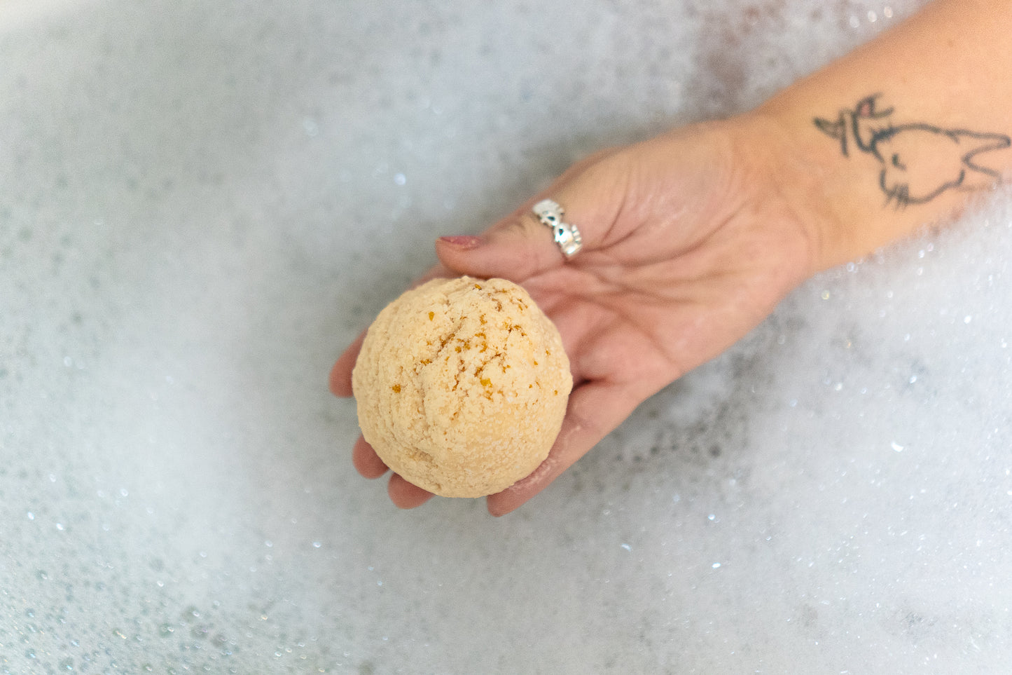 vanilla madagascar bath truffle in a warm bubbly bath, handmade in brighton skincare bath & body warm scent bath bomb shea butter vegan