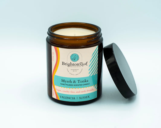 Brighton Rock Workshop Myrrh & Tonka scented candle in amber glass jar with black lid. 150g hand poured and handcrafted with love, purity, and passion in Alicante, Spain. Eco-friendly and recyclable, vegan friendly and cruelty free. You are donating to Fripps Farm animal rescue with every purchase.