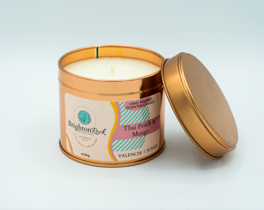 thai peach, mango, and citrus scented candle in a rose gold tin with matching lid. Brighton Rock Workshop strongly-scented candles. 190g eco-friendly, sustainable, recyclable packaging, vegan friendly and cruelty free